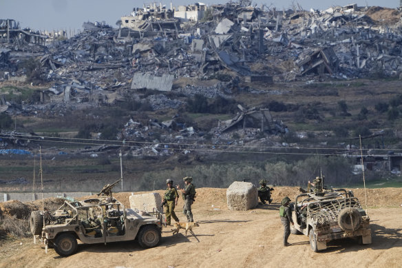 Israeli soldiers take up positions near the Gaza Strip border.
