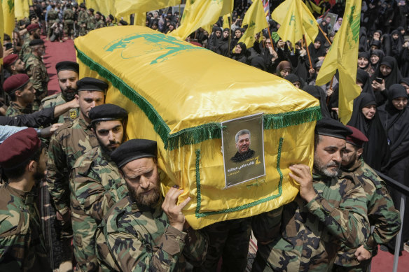 Hezbollah fighters carry the coffin of their comrade, senior commander Taleb Sami Abdullah, 55, known within Hezbollah as Hajj Abu Taleb, who was killed late Tuesday by an Israeli strike in south Lebanon.