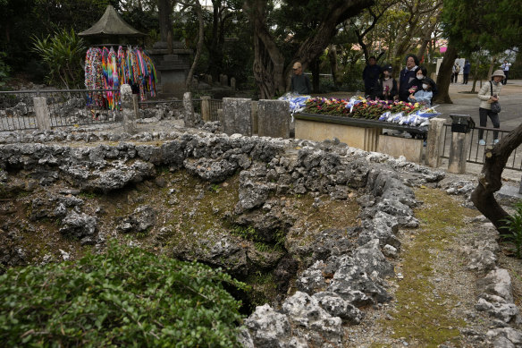 Visitors bring flowers and pray at the “Himeyuri” cenotaph (not in picture), created by a cave in Itoman, on the main island of the Okinawa archipelago.