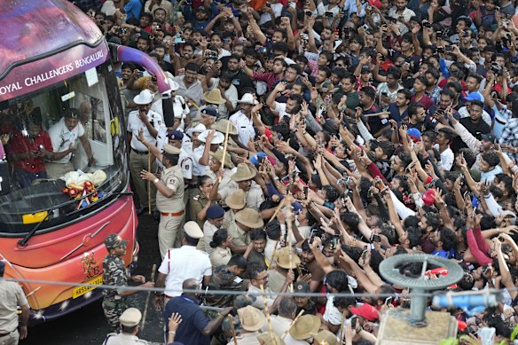 Fans cheer as the bus carrying Royal Challengers Bengaluru cricketers arrive at the M. Chinnaswamy Stadium in Bengaluru, India.