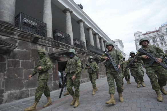 Soldiers patrol outside the government palace during a state of emergency in Quito.