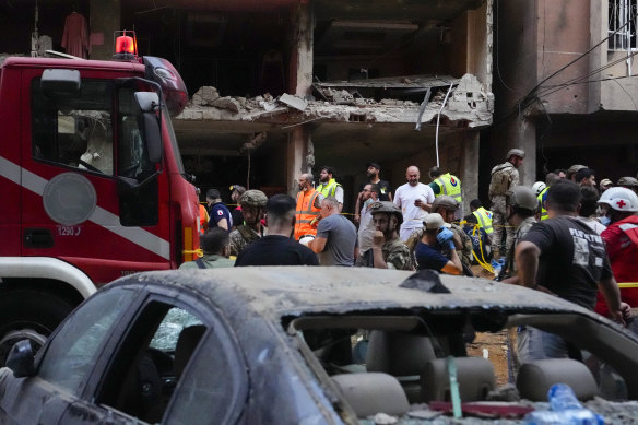 Rescuers work at the scene of an Israeli missile strike in the southern suburbs of Beirut.