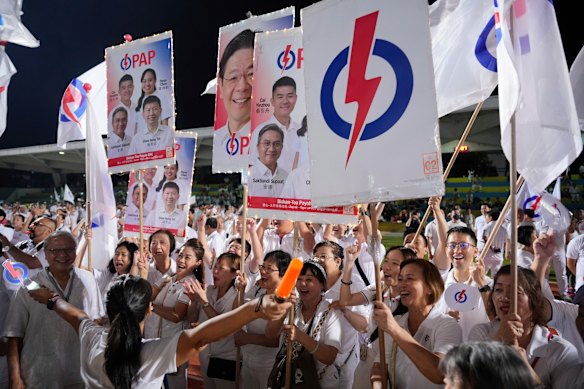 Supporters of ruling People’s Action Party cheer after the decisive win.
