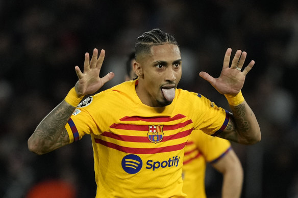 Raphinha celebrates scoring Barcelona’s opener against PSG.