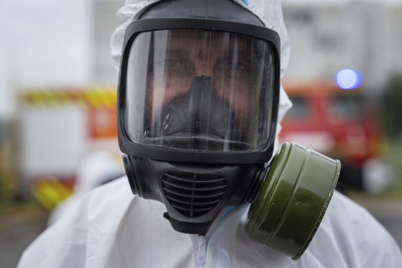 A Ukrainian emergency worker wearing a radiation protection suit attends training in Zaporizhzhia.