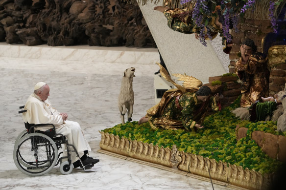 Pope Francis pauses in front of a nativity scene set up in Paul VI Hall at The Vatican at the end of his weekly general audience on Wednesday, December 14.