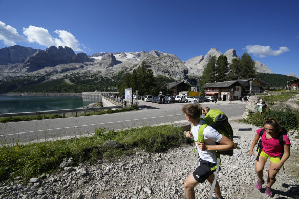 Hikers walk past the Marmolada mountain near wher<em></em>e 11 hikers died as glaciers melt and become more unstable.