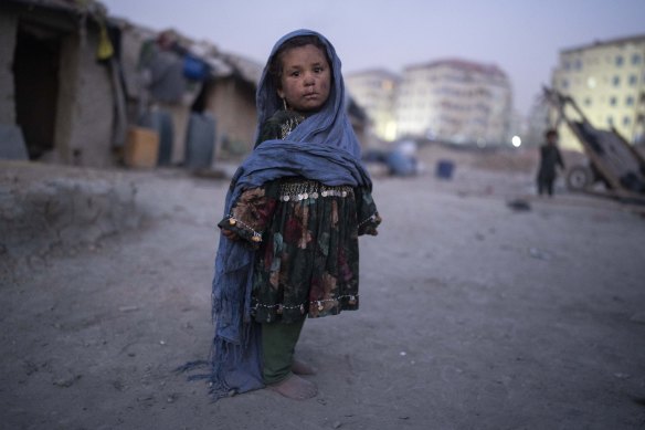 A child stands outside her home in a neighbourhood where many internally displaced people have been living for years, in Kabul, Afghanistan, on Tuesday.