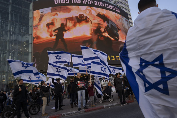 Right-wing activists wave Israeli flags during a protest against Israel’s Prime Minister Naftali Bennett in Tel Aviv on Wednesday, following a recent wave of violence.