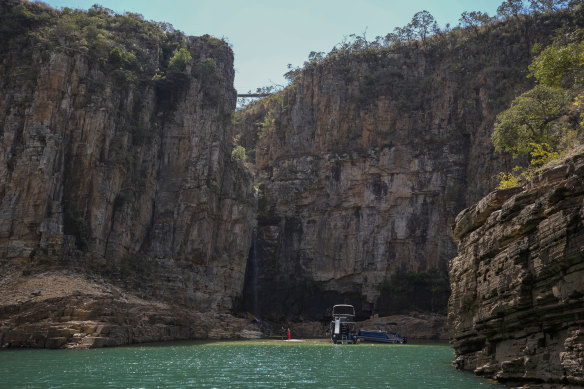 A tourist boat navigates through a canyon in Furnas Lake, near Capitolio City, Brazil. A massive slab of rock broke away at the weekend, killing at least seven people.