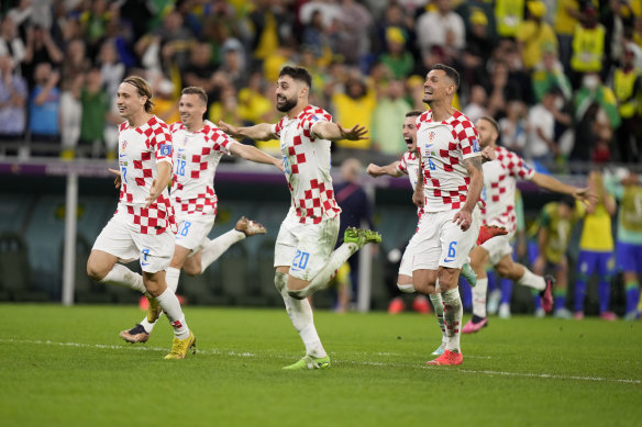 Croatia players react at the end of the World Cup quarterfinal soccer match.