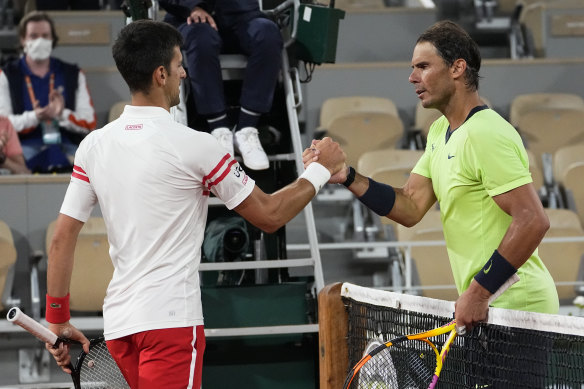 Novak Djokovic and Rafael Nadal shake hands after their semi-final at Roland-Garros last year.