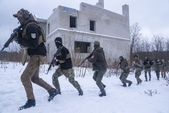 Members of a Ukrainian far-right group train in Kharkiv, Ukraine, on Saturday, January 29, as the Ukraine tourism board urges people to visit the “sleepless” border city at the centre of the crisis.