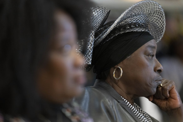 Marian Markelo, a Winti Priest, an Afro-Surinamese traditional religion, right, listens to Dutch Prime Minister Mark Rutte’s apology.