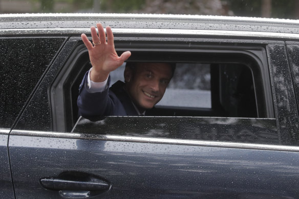 French President Emmanuel Macron leaves after voting on Sunday.