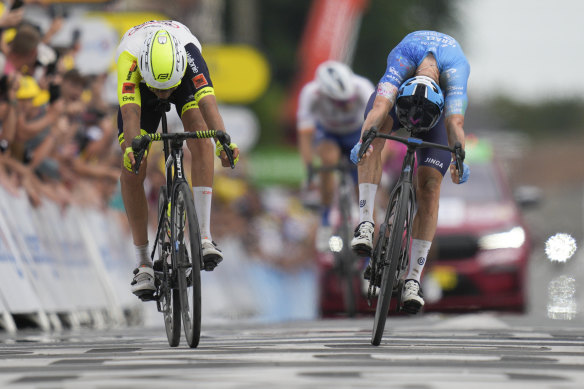 Stage winner Australia’s Simon Clarke, right, pushes his wheel over the finish line ahead of Netherlands’ Taco van der Hoorn.