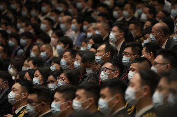 Masked delegates attend the opening ceremony of the 20th National Congress of the ruling Communist Party of China at the Great Hall of the People in Beijing on Sunday.