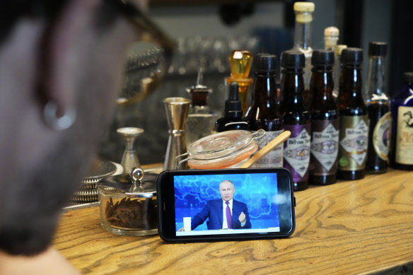 A man watches a live stream of Russian President Vladimir Putin’s annual televised call-in show, in a bar in Moscow, last year. Russians have been fed a diet of propaganda by the Kremlin for years.