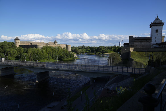 A bridge straddles Ivangorod, Russia, left, and a border crossing in Narva, Estonia.