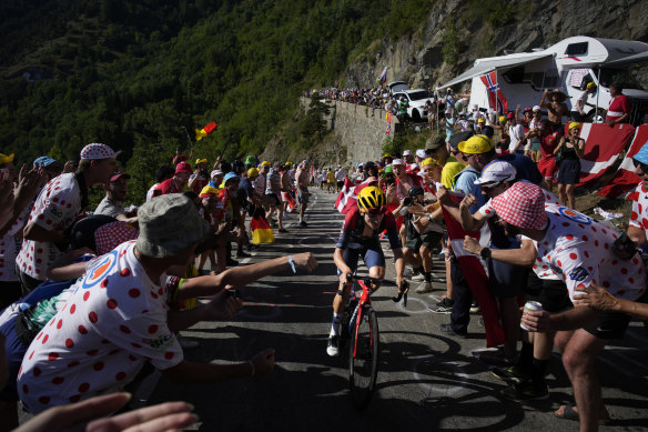 Tom Pidcock threads his way through the crowds on Alpe d’Huez.