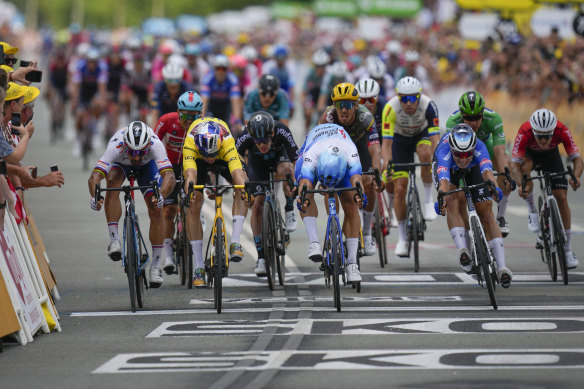 Redemption: Dylan Groenewegen (in light blue and white) wins stage three of the 2022 Tour de France in a photo finish. 