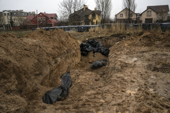 Bodies lie in a mass grave in Bucha outside Kyiv.