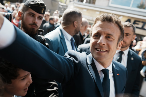 French President Emmanuel Macron heads to the polling station on Sunday.