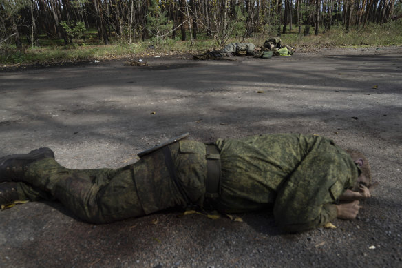 The bodies of Russian soldiers lie on the ground in the recently recaptured city of Lyman.