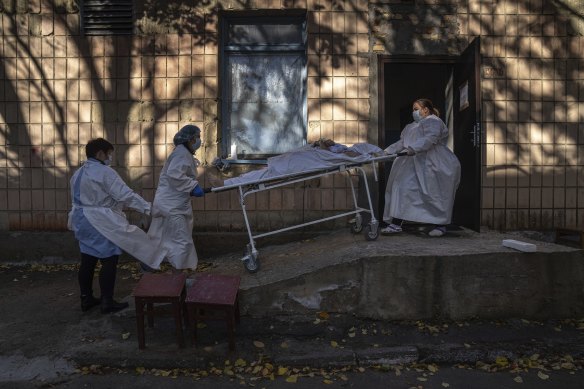 Medical staff members transport the body of a patient who died of COVID-19 in Rivne, Ukraine last month.