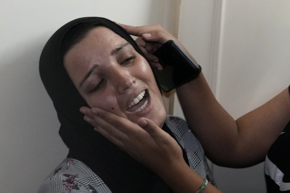 A relative of two victims who were on a boat carrying migrants from Lebanon that sank in Syrian waters, is comforted as she mourns at a house in Tripoli, north Lebanon.