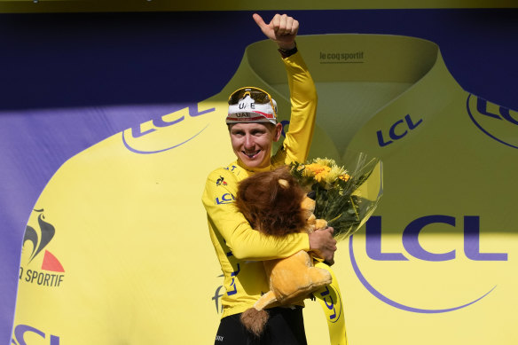 Tadej Pogacar on the podium in the yellow jersey. 