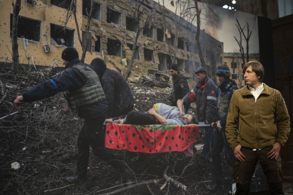 AP photographer Evgeniy Maloletka with his World Press Photo of the Year image of Iryna Kalinina, a pregnant woman rescued from the Mariupol maternity hospital after a Russian strike. Both Kalinina and her baby later died.