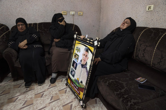 Mother of Adam Shaath mourns during his funeral in Khan Younis, in the southern Gaza Strip.