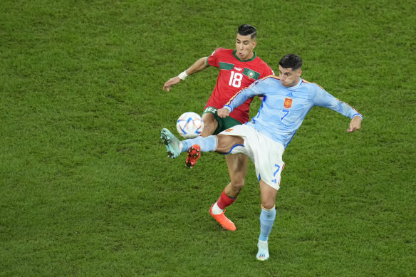 Spain's Alvaro Morata (right) battles for the ball with Morocco's Javad El Yamic.