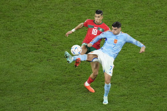 Spain’s Alvaro Morata (right) fights for the ball with Morocco’s Jawad El Yamiq.