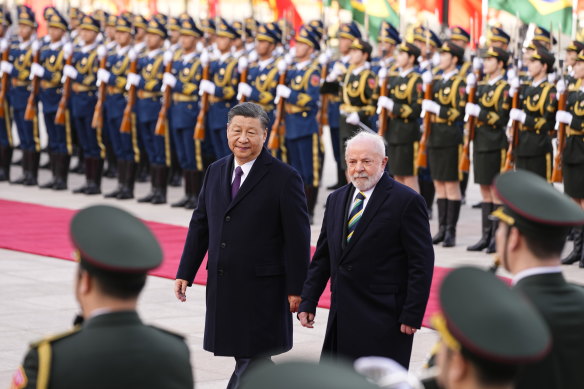 Brazilian President Luiz Inacio Lula da Silva, right, inspects an honour guard with Chinese President Xi Jinping during a welcome ceremony held outside the Great Hall of the People in Beijing.
