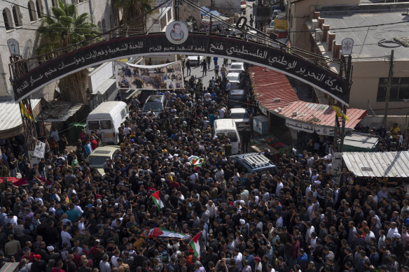 A boy cries while mourners take the last look at the body of Ramzi Zabarah, 35, at the family house, during his funeral.