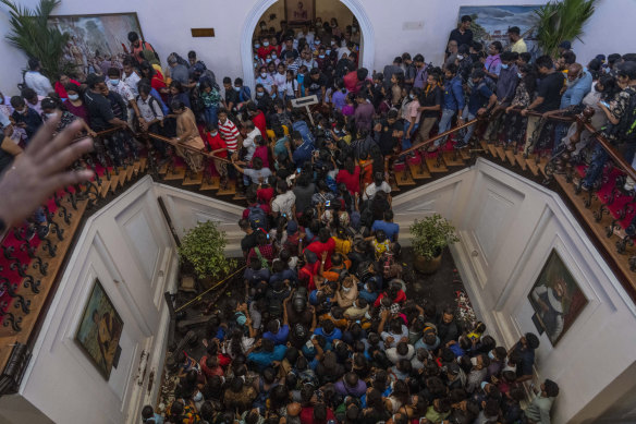 People throng then-president Gotabaya Rajapaksa’s official residence in Colombo, Sri Lanka, on July 11, a day after it was stormed by protesters demanding his resignation amid the country’s worst economic crisis in recent memory. 
