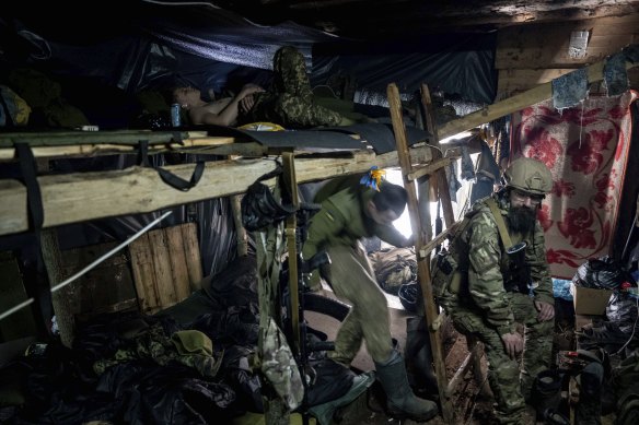 Ukrainian paratroopers of 80 Air Assault brigade rest inside a dugout at the frontline near Bakhmut on Friday.