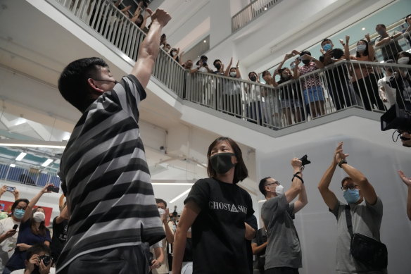 Staff applaud Chan Pui-man, right, associate publisher of Apple Daily and Lam Man-chung, executive editor-in-chief of Apple Daily after the final edition is sent to the printers. 