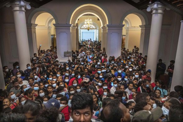 People throng President Gotabaya Rajapaksa’s official residence in Colombo, Sri Lanka, for the second day after it was stormed  on Saturday.