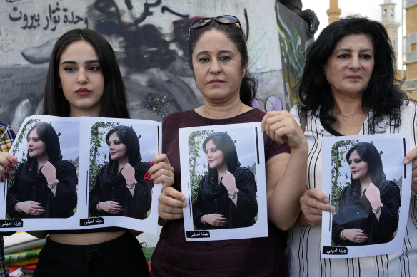 Kurdish women activists hold portraits of Iranian Mahsa Amini, during a protest against her death in Iran, at Martyrs’ Square in Beirut.