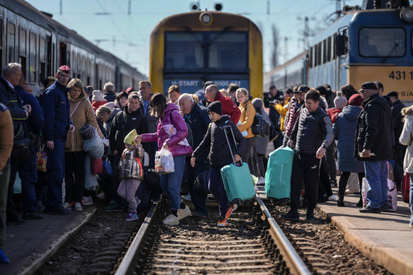 Ukrainian refugees continue to stream across European borders. Here, people queue to board a train in Zahony, Hungary.