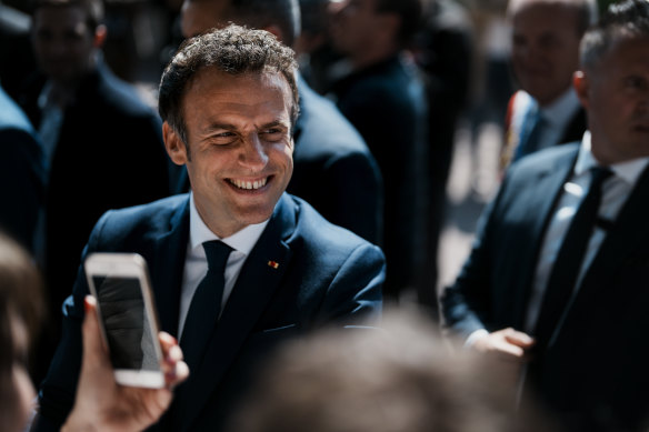 French President and centrist candidate Emmanuel Macron greets well-wishers after casting his vote in Le Touquet, northern France, Sunday.