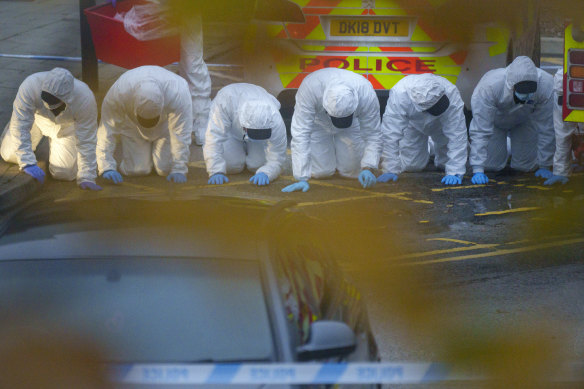 Police and forensic officers carry out a fingertip search at England’s Liverpool Women’s Hospital on Monday.