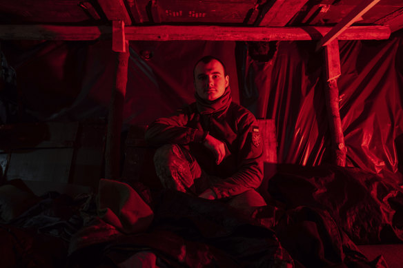 Vladyslav, a Ukrainian paratrooper of the 80 Air Assault brigade, rests inside a dugout at the frontline near Bakhmut on Friday.