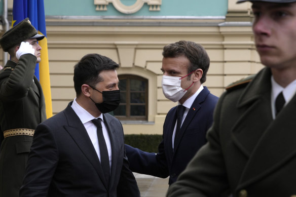 French President Emmanuel Macron, right, is welcomed by Ukrainian President Volodymyr Zelensky before their talks in Kyiv.