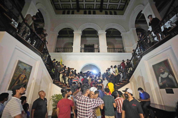 Protesters storm the Sri Lankan president’s official residence in Colombo on Saturday.