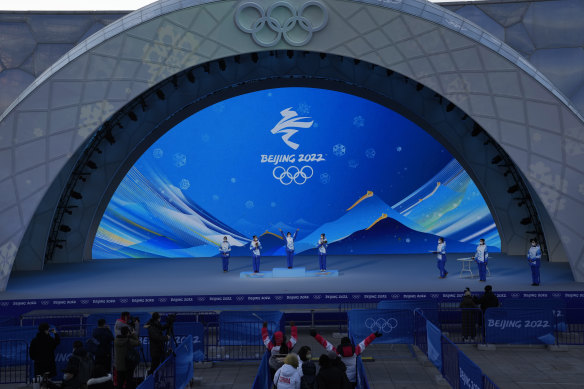Staff members rehearse a medals ceremony ahead of the Winter Olympics in Beijing.