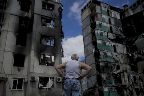 A man looks at buildings destroyed during Russian attacks on Borodyanka on the outskirts of Kyiv.